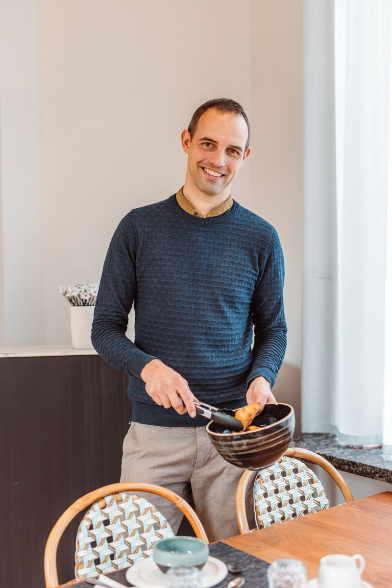 Portret Tomas met kom met croissants en tang om te bedienen.